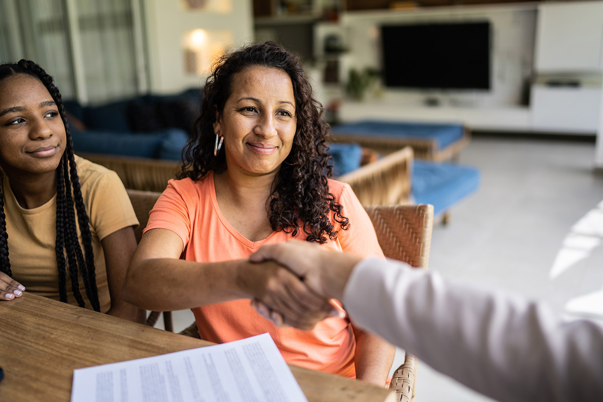 Professional consultant handshake with customer during a home visit